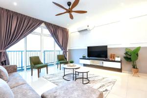 a living room with a couch and a tv at NOVO 8 Residence Melaka in Malacca