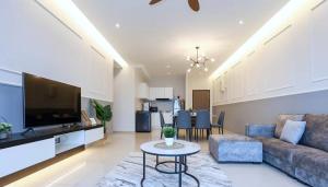 a living room with a couch and a table at NOVO 8 Residence Melaka in Malacca
