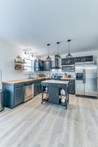 een grote keuken met blauwe kasten en roestvrijstalen apparatuur bij Hilltop Hideaway - Pool - Jacuzzi - Ping Pong - 12 guests - Fireplace - Mountain Views - Pets are allowed by request in Roseland