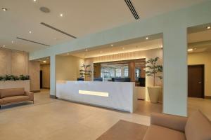 an office lobby with a reception desk and chairs at Wyndham Garden Saltillo in Saltillo