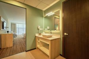 a bathroom with a sink and a mirror at Wyndham Garden Saltillo in Saltillo +37 photos
