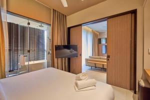 En eller flere senge i et værelse på Antara Premium Suites by Byon Genting Highlands + 68 billeder