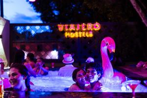 a group of people in a swimming pool with a pink swan at Viajero Oaxaca Hostel in Oaxaca City
