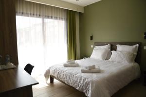 a bedroom with a bed with two towels on it at Résidence Soavina in Antananarivo