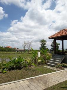 a garden with a gazebo and stairs and plants at Svadarma Bali Villa in Darmasaba +5 photos