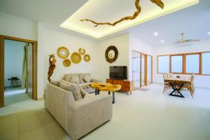 a living room with a couch and a table at Danka Luxury Villa in Batam Center