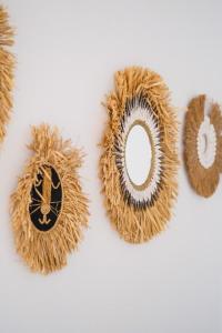 a group of straw wreaths on a white wall at Danka Luxury Villa in Batam Center