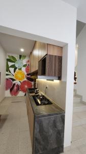 a kitchen with a stove top oven in a room at Danka Luxury Villa in Batam Center