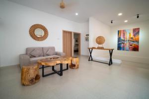a living room with a couch and a wooden coffee table at Danka Luxury Villa in Batam Center +22 photos