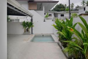 a swimming pool in the courtyard of a house at Coconut Breeze Villa #2 in Haad Chao Phao