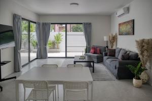 a living room with a table and a couch at Coconut Breeze Villa #2 in Haad Chao Phao