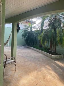 an empty patio with palm trees in a house at Bela casa com piscina in Mongaguá