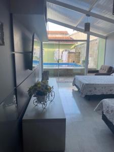 a room with a table with flowers on it at Bela casa com piscina in Mongaguá