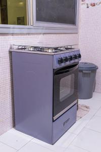 a kitchen with a stove and a trash can at Camara Homes in Saint-Louis +11 photos