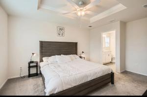 a bedroom with a large bed with a ceiling fan at Modern Retreat with Private Office in Heath