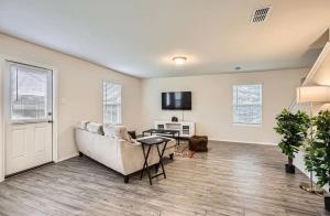 a living room with a couch and a table at Modern Retreat with Private Office in Heath