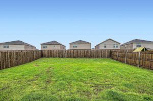 a backyard with a fence and some houses at Modern Retreat with Private Office in Heath