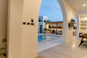 a living room with a swimming pool and a house at Merry Holmes Resort Hatyai in Ban Tha Sae