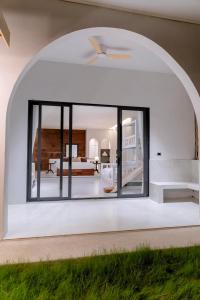 an open living room with a large window at Merry Holmes Resort Hatyai in Ban Tha Sae