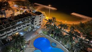 an aerial view of a hotel at night with a blue pool at Gamers Residence in Ban Nong Chaeng