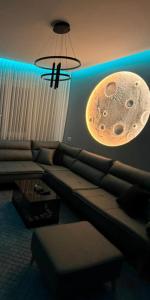 a living room with a couch and a moon light at Feel Home Apartment in Kamëz