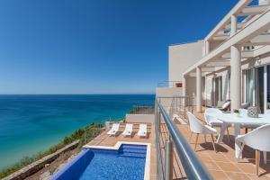 a view of the ocean from the balcony of a house at Villa Mar à Vista by VILA VITA Collection in Salema