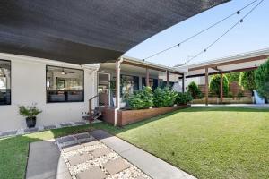 a house with a lawn in the front yard at The Break in Lennox Head