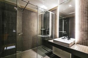ein Badezimmer mit Waschbecken und Glasdusche in der Unterkunft Daesungkwan Hot Spring Hotel in Busan + 6 Fotos