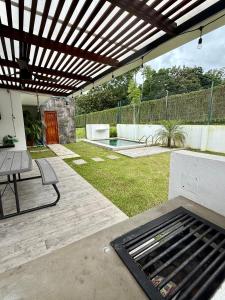 a patio with a grill and a table and a fence at Casa kai in Agujas