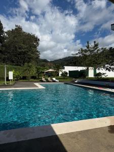 a large swimming pool with blue water at Casa kai in Agujas +21 photos