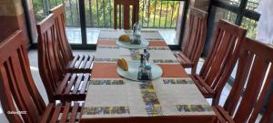 a wooden table with chairs and a table with two sinks at Kings Land Hotel in Lalībela +25 photos