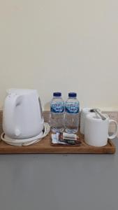 a cutting board with two bottles of water and a toaster at Jepun Bali Homestay Sanur in Sanur