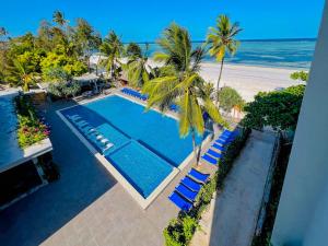 an overhead view of a swimming pool with chairs and the beach at Matemwe Sands Hotel in Mkuyuni Pwani