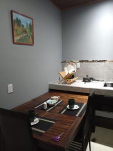 a wooden table with cups and plates on top of it at Yamis home in General Viejo