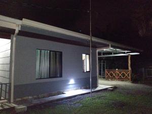 a house with a light on the side of it at night at Yamis home in General Viejo