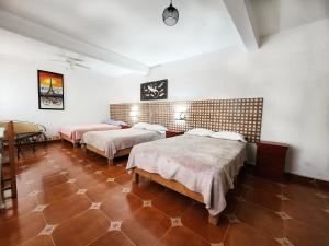 En eller flere senge i et værelse på Hacienda San Miguel