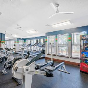 a gym with a bunch of treadmills and machines at 4BD 2 MI to USF Free Pool + 24 Hour Gym in Tampa +64 photos
