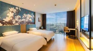 Postel nebo postele na pokoji v ubytování Magnotel Tongxiang Shimao Center + 145 fotografií