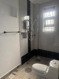 a bathroom with a white toilet and a window at Serene 3-Bedroom House in Pridelands, Nairobi in Syokimau +79 photos