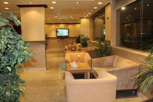 a lobby with couches and tables in a building at Makarim Najd 4 in Riyadh