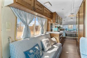 a living room with a couch in an rv at Starlite Vintage Resort in Buckskin Joe