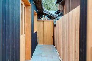 a hallway of a house with a wooden fence at Nui in Minamiawaji
