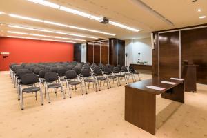 a conference room with a row of chairs and a podium at Hotel Garden Istra Plava Laguna in Umag