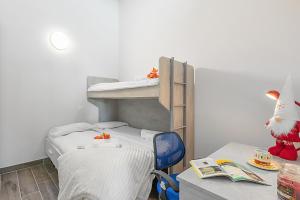 Giường trong phòng chung tại Tana Delle Volpi - Happy Rentals