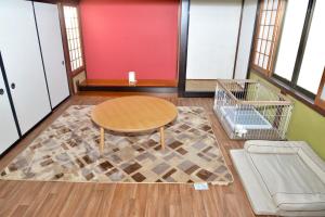 a room with a table and a rug at 高岡ゆるり家 Yururi-Ya in Takaoka +53 photos