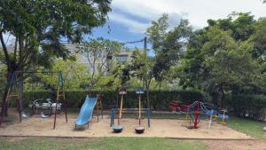 a playground with a blue slide and swings at Cozy Clifford Homagama in Homagama