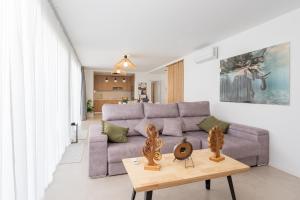 a living room with a couch and a table at Villa Trilux, Infinity Pool, Jacuzzi, BBQ in Salobre