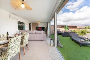 a living room with a couch and a table at Villa Trilux, Infinity Pool, Jacuzzi, BBQ in Salobre