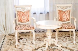 two chairs and a white table and two chairs at Maximus hotel in Luts'k