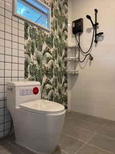 a bathroom with a white toilet in a room at Woodland Residence in Wok Tum +43 photos